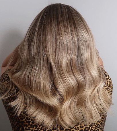 24 ایده جذاب رنگ موی بلوند تیره + (برای ظاهری لوکس و طبیعی) 6 Back of woman s head with wavy sandy blonde hair created using Wella Professionals. 2