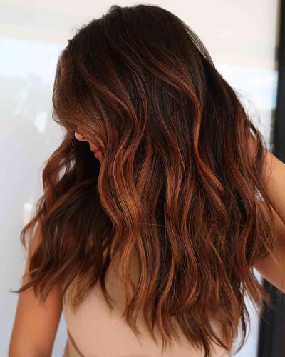 auburn cinnamon balayage highlights on brunette hair e1759666644870