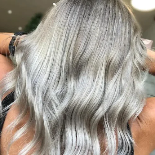 Back of woman s head with long wavy gray blonde hair created using Wella Professionals e1762338004766